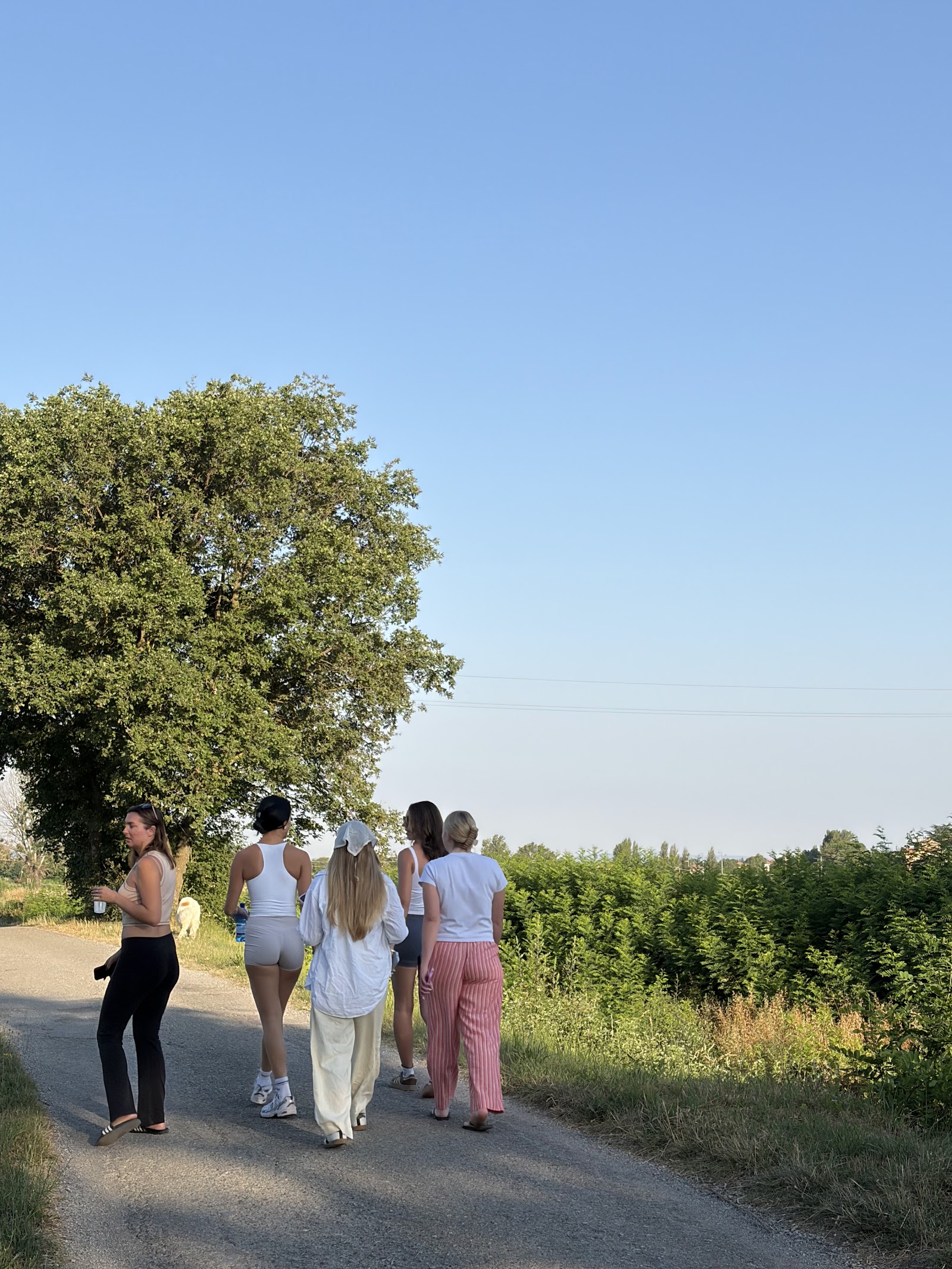 Women walking a country road through the Tuscan hills