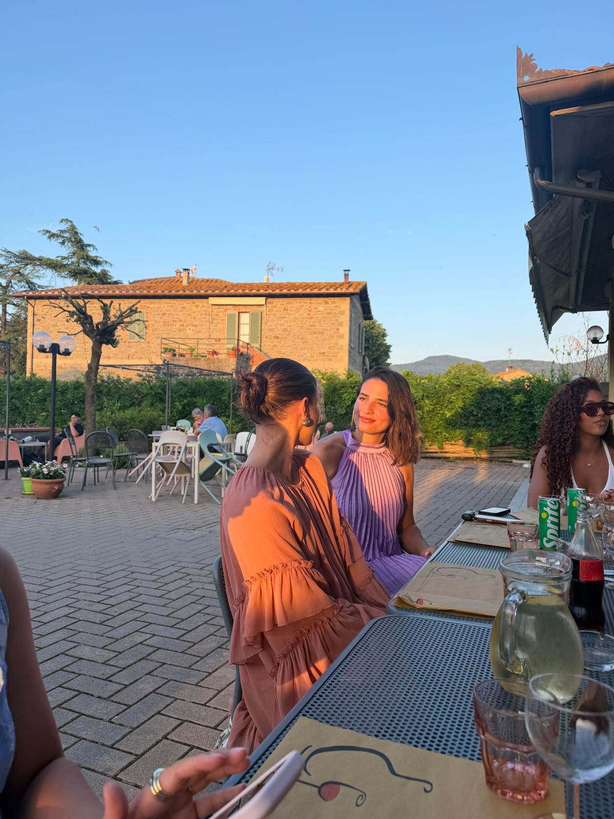 Women at a long table at golden hour