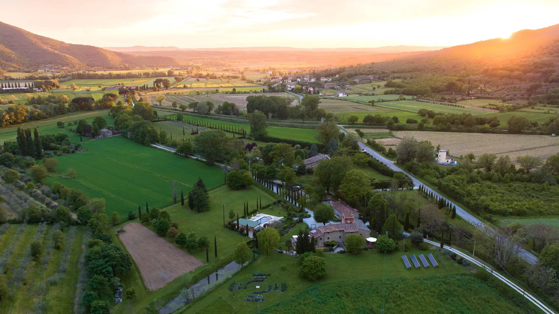 Aerial view of the villa and Tuscan valley at sunset
