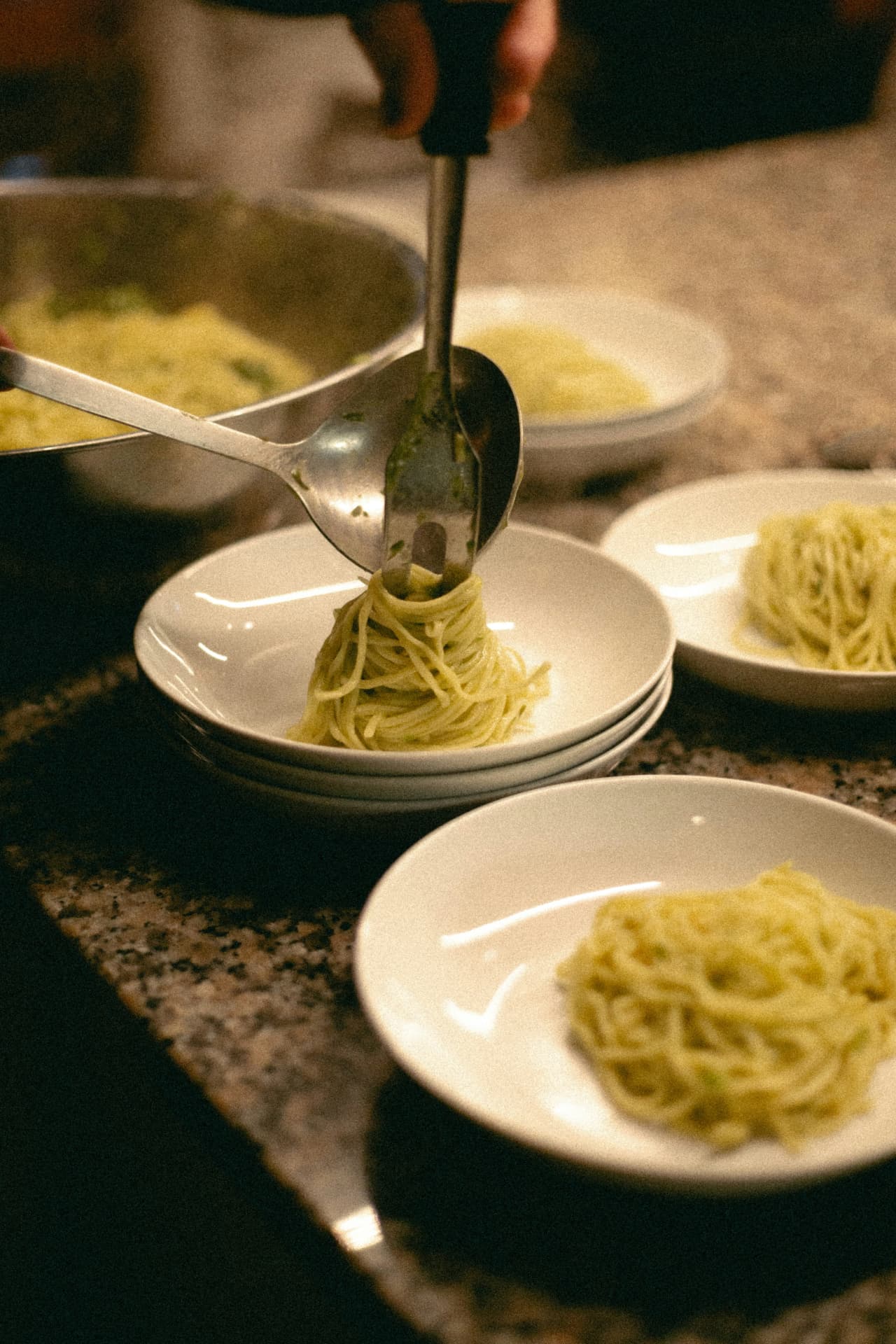 Plates of fresh pasta being served in the villa kitchen